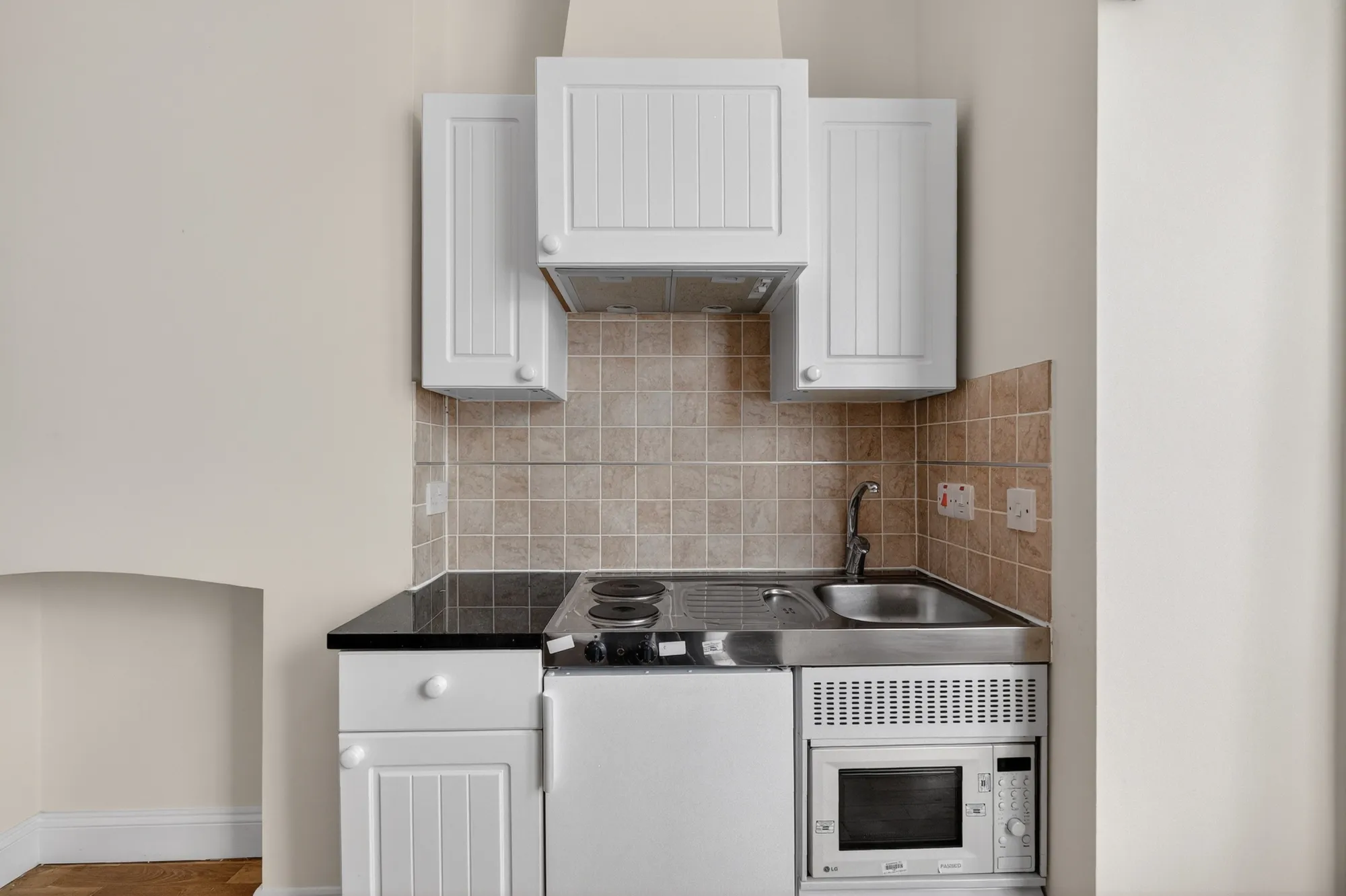 Private in-room kitchenette with storage, sink, microwave and cooking facilities at Pinfold Care Home