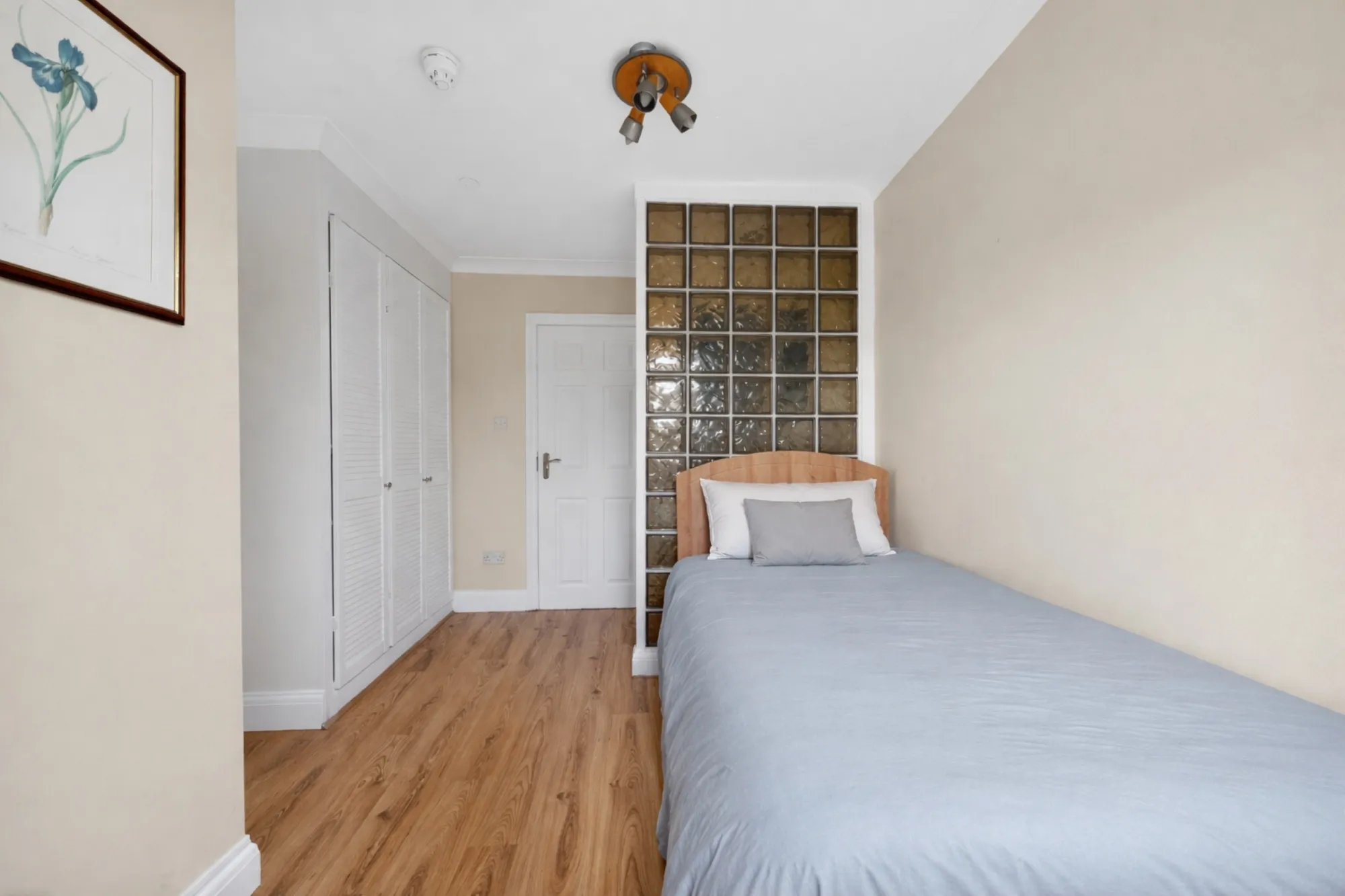 Comfortable private single bedroom with storage and natural light for residents at Pinfold Care Home