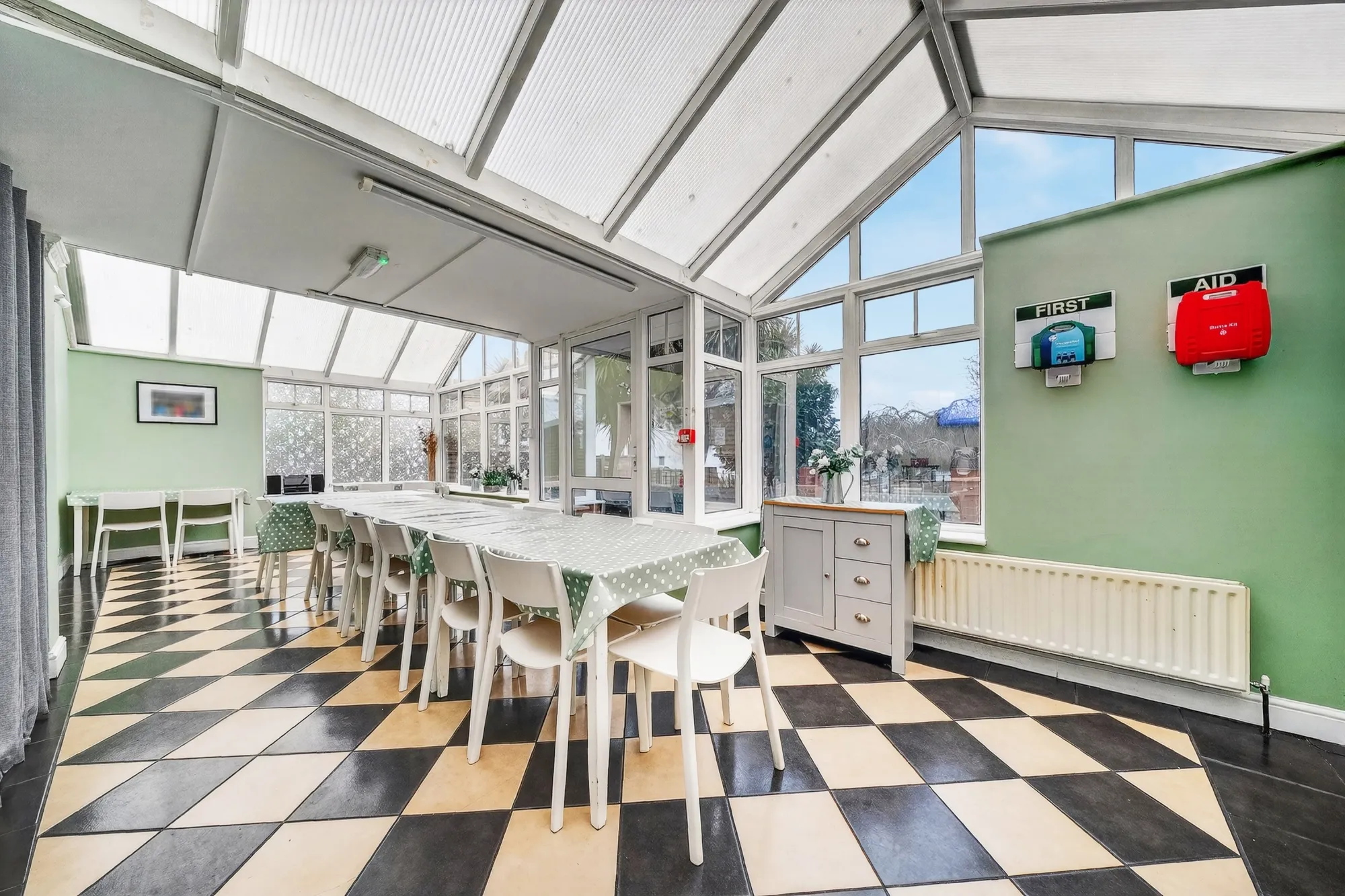 Spacious communal dining room with natural light and comfortable seating at Pinfold Care Home
