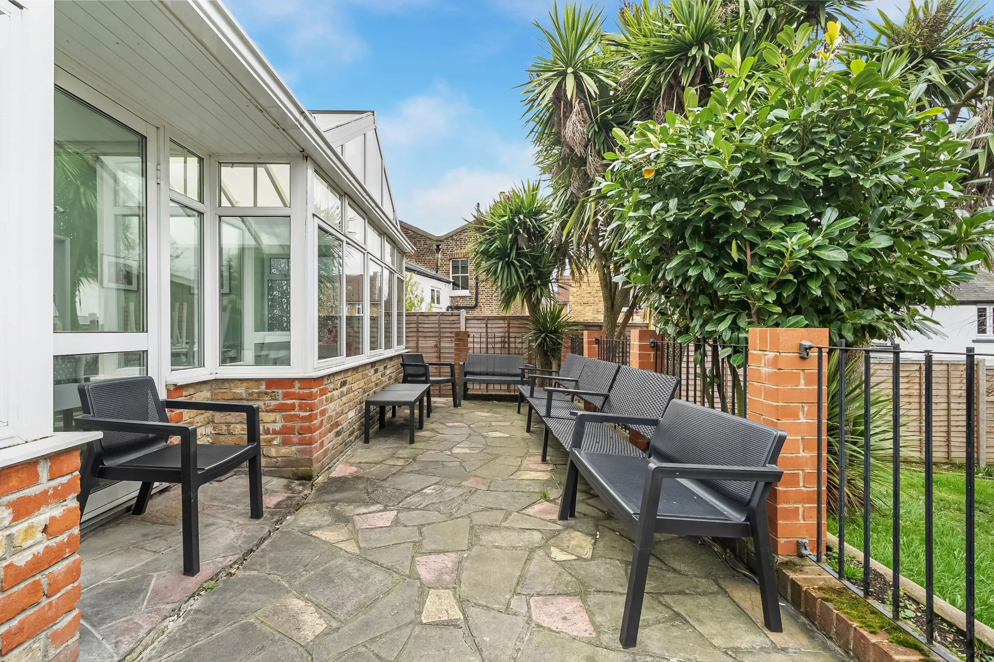 Secure garden patio with outdoor seating area for residents to relax and socialise at Pinfold Care Home